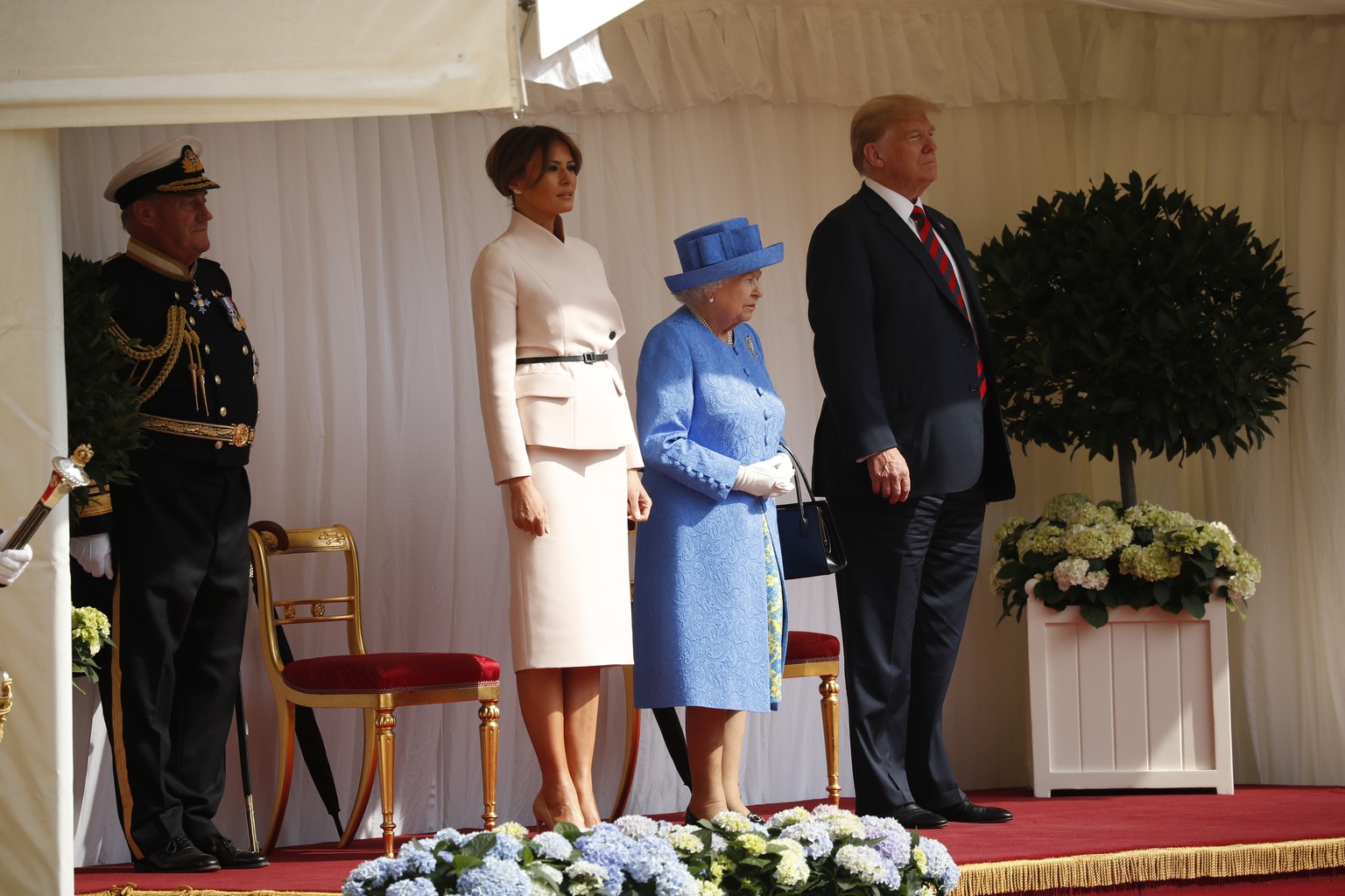 U.S. President Donald Trump, first lady Melania Trump, with Queen Elizabeth II, stand during an arrival ceremony with the Guard of Honour at Windsor Castle in Windsor, England, Friday, July 13, 2018.  ...