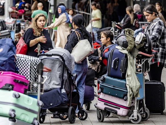 epa10091217 Passengers of flight XC5078 are waiting at Rotterdam The Hague Airport, the Netherlands, 25 July 2022. About 170 passengers had already checked in for their Corendon flight to Ankara on 24 ...