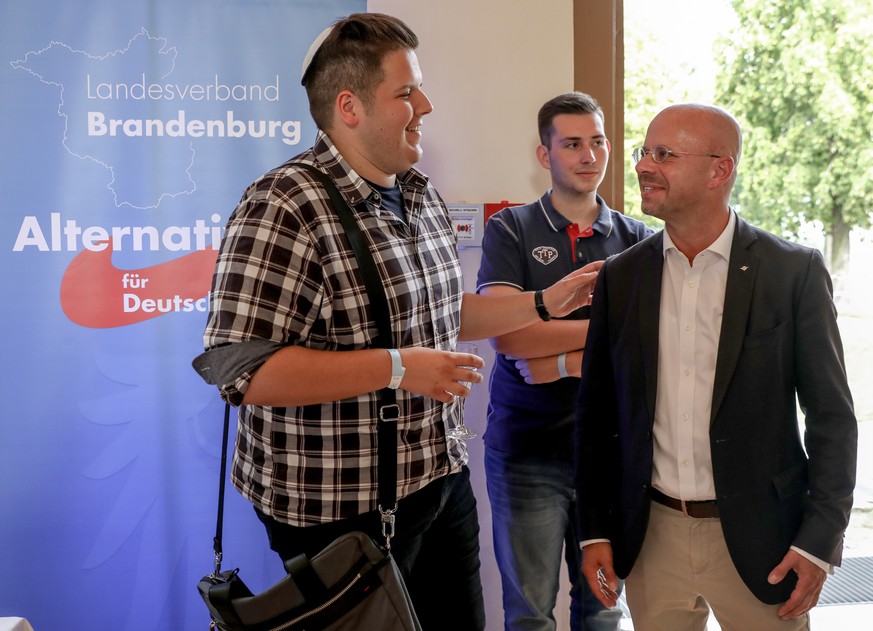 epa07810307 Brandenburg chairman and top candidate of the Alternative for Germany (AfD) right-wing populist party Andreas Kalbitz (R) talks to a supporter of the group 'Jews for AfD' on the AfD electi ...
