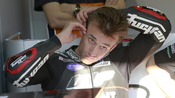 Moto2 driver Johann Zarco of France puts an earplug during the qualifying session for the MotoGP Japanese Motorcycle Grand Prix at the Twin Ring Motegi circuit in Motegi, north of Tokyo, Saturday, Oct ...