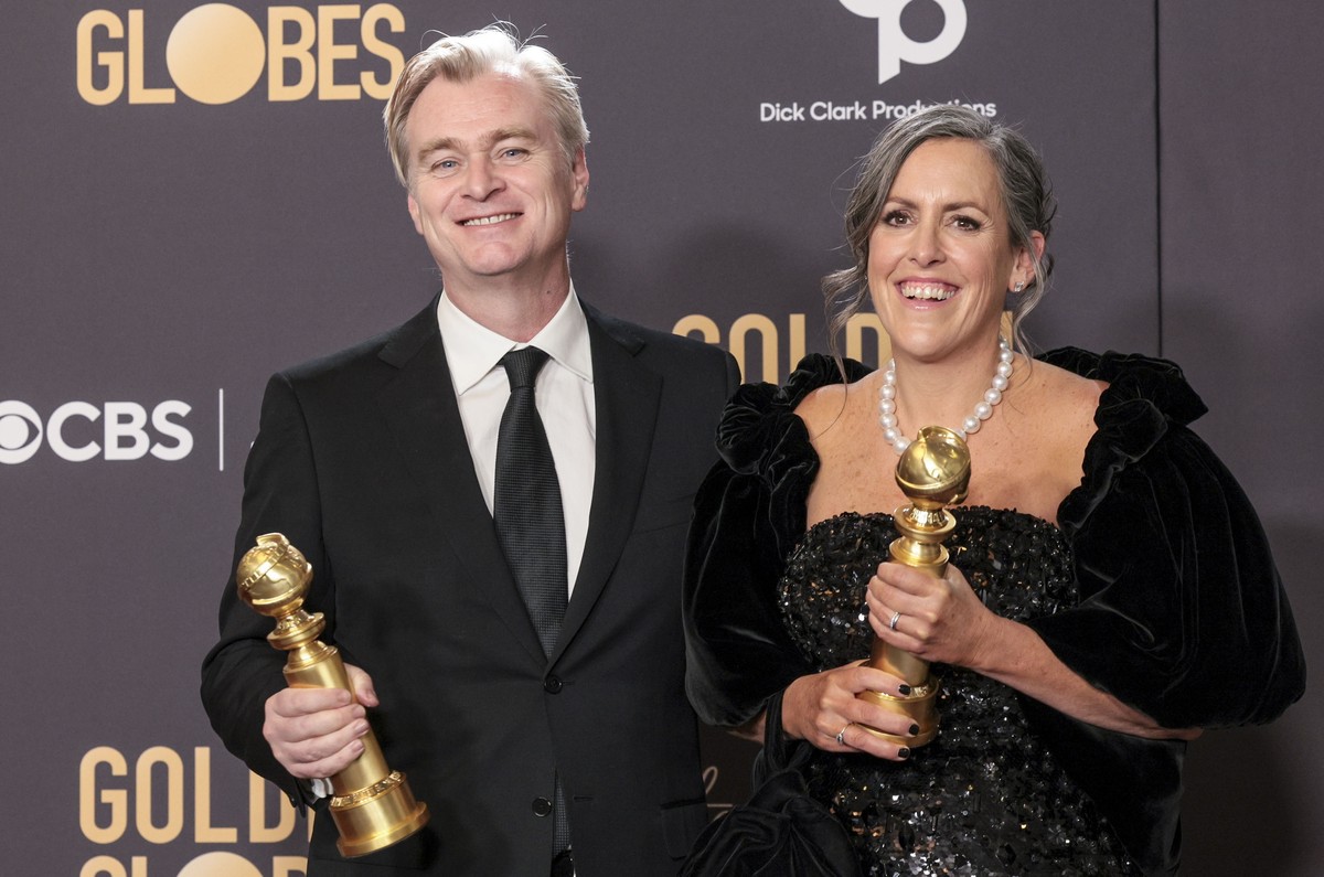 epa11063635 British director Christopher Nolan (L) and British film producer Emma Thomas (R) hold their Golden Globe awards for Best Director - Motion Picture and Best Motion Picture - Drama for ' ...