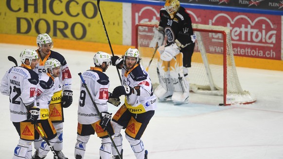 Zug&#039;s player Dennis Everberg, celebrates the score 2-2 goal against Lugano&#039;s goalkeeper Elvis Merzlikins, during the fourth leg of the playoff quarterfinals of the ice hockey National League ...