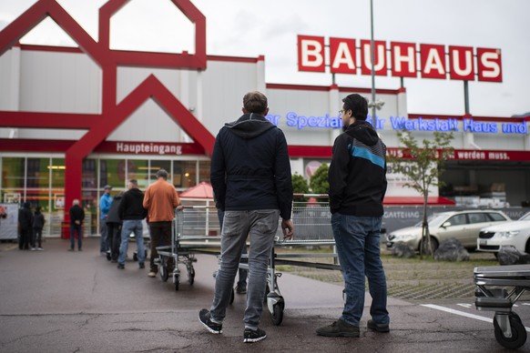 Kunden stehen Schlange um sieben Uhr morgens vor der Wiedereroeffnung des &quot;Bauhaus&quot; Bau- und Gartencenter, augenommen waehrend der Coronavirus-Pandemie, am Montag, 27. April 2020, in Mels. M ...