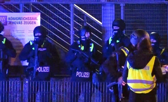 epa10512704 Armed police officers stand guard near the scene of a shooting in Hamburg, Germany, 09 March 2023. According to police, the shooting took place around 9 pm, killing seven people and injuri ...