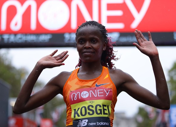 epa08719075 Brigid Kosgei of Kenya gestures after crossing finish line in the elite women?s race during the London Marathon in London, Britain, 04 October 2020. EPA/Richard Heathcote / POOL