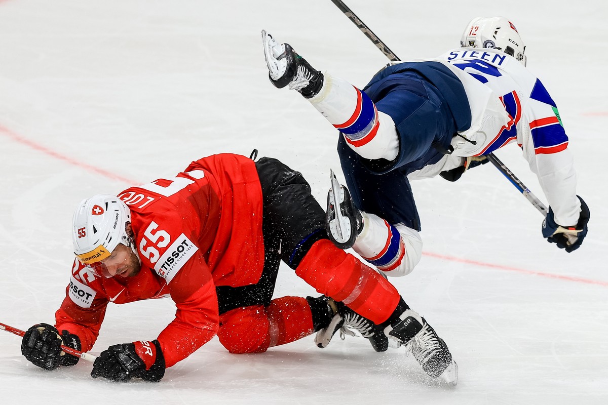 epa11331648 Romain Loeffel of Switzerland (L) in action against Noah Steen of Norway (R) during the preliminary round group A match between Switzerland and Norway at the IIHF Ice Hockey World Champion ...