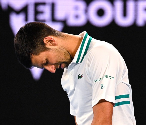 epa09688757 (FILE) - Novak Djokovic of Serbia reacts during his men&#039;s singles fourth round match against Milos Raonic of Canada at the Australian Open Grand Slam tennis tournament at Melbourne Pa ...