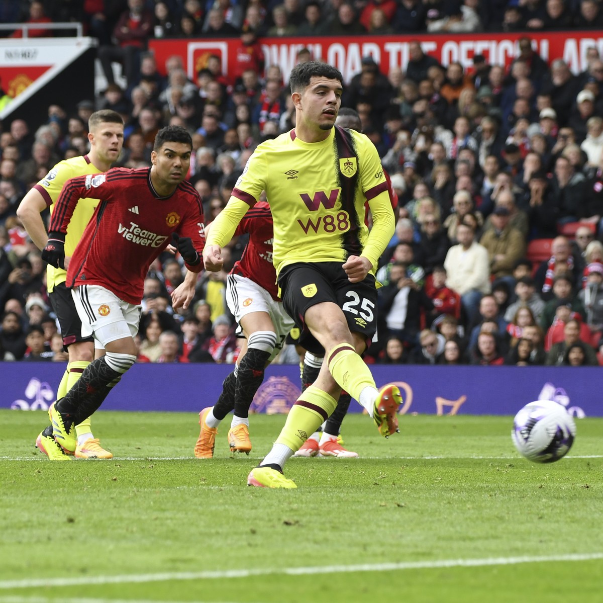 Burnley's Zeki Amdouni scores his side's opening goal from the penalty spot during the English Premier League soccer match between Manchester United and Burnley at Old Trafford stadium in Ma ...