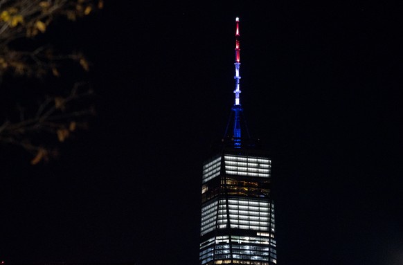 As ordered by New York Gov. Andrew Cuomo, the spire of One World Trade Center is illuminated in red, white and blue following a deadly rampage down a bike path not far from the building Tuesday, Oct.  ...