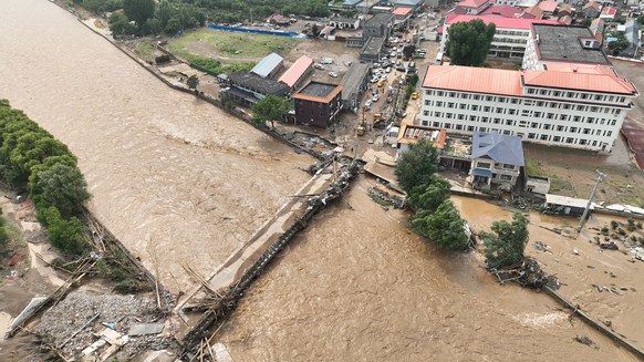 epa12269480 An aerial photo shows a road and a bridge affected by flood at Xiaying Village of Xiaying Town, Jizhou District of north China&#039;s Tianjin, 28 July 2025 (issued 29 July 2025). Houses, b ...