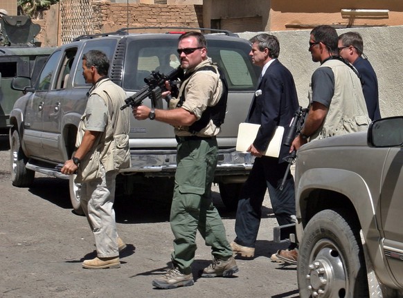 epa04703773 (FILE) A file photo dated 08 September 2003 showing US guards of the Blackwater security company protecting Paul Bremer, the U.S. civilian administrator in Iraq (3-L), as he arrives to mee ...