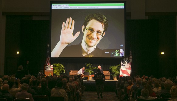 NSA leaker Edward Snowden appears on a live video feed broadcast from Moscow at an event sponsored by the ACLU Hawaii in Honolulu on Saturday, Feb. 14, 2015. (AP Photo/Marco Garcia)