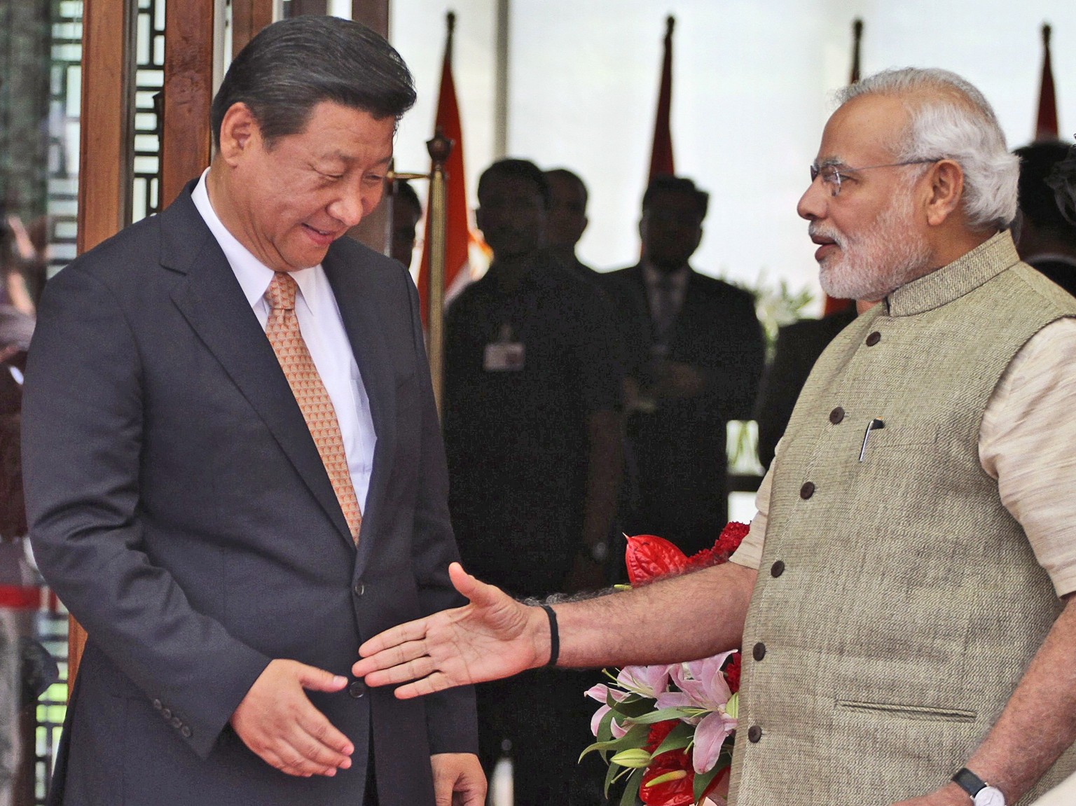 FILE- Indian Prime Minister Narendra Modi welcomes Chinese President Xi Jinping upon the latter&#039;s arrival at a hotel in Ahmadabad, India, Wednesday, Sept. 17, 2014. India is protesting a new Chin ...