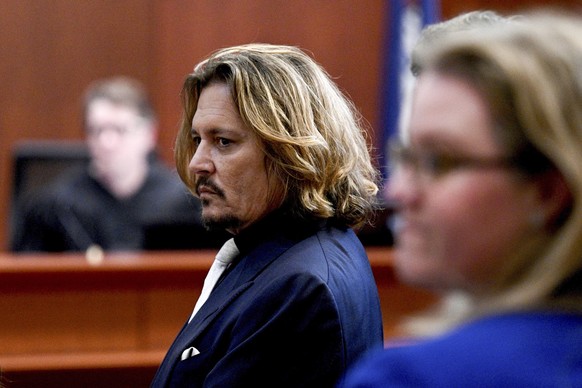 Actor Johnny Depp appears in the courtroom at the Fairfax County Circuit Court, Tuesday, April 12, 2022, in Fairfax, Va. A jury in Virginia is scheduled to hear opening statements in a defamation laws ...