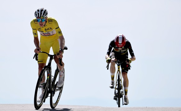 epa12253498 Yellow Jersey overall leader Slovenian rider Tadej Pogacar of UAE Team Emirates approaches the finish line ahead of Danish rider Jonas Vingegaard of Team Visma-Lease a Bike in the 16th sta ...