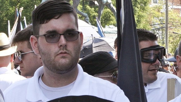 FILE - In this Saturday, Aug. 12, 2017, file photo, James Alex Fields Jr., left, holds a black shield in Charlottesville, Va., where a white supremacist rally took place. Fields Jr., of Maumee, Ohio,  ...