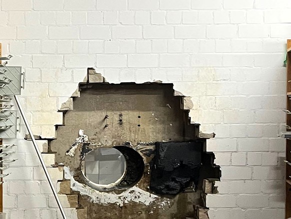 This picture, provided by the Gelsenkirchen Police on Monday, Dec. 29, 2025 shows a hole in a wall of the savings bank branch in the Buer district in Gelsenkirchen, Germany. (Police Gelsenkirchen via  ...