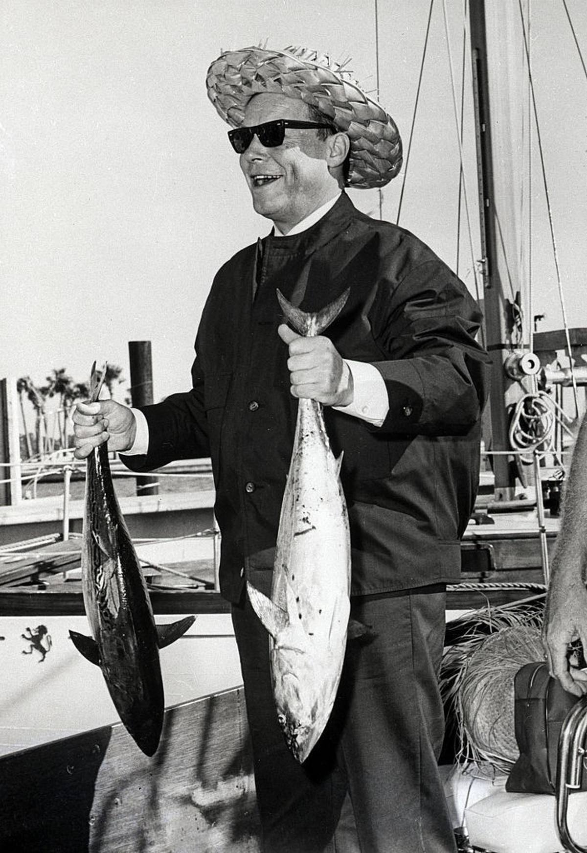 (Original Caption) 4/17/1965-Sarasota, FL: West Berlin's Mayor Willy Brandt, wearing his best Florida straw hat, is all smiles as he holds up two large kingfish he caught on an all-day fishing ja ...