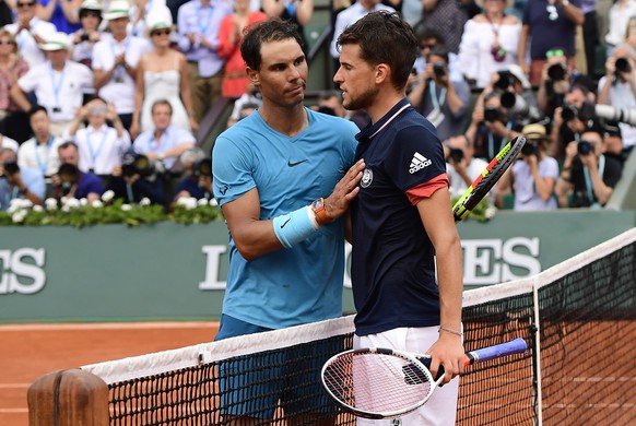 epa06799019 Rafael Nadal of Spain (L) reacts with Dominic Thiem of Austria after winning their men’s final match during the French Open tennis tournament at Roland Garros in Paris, France, 10 June 201 ...