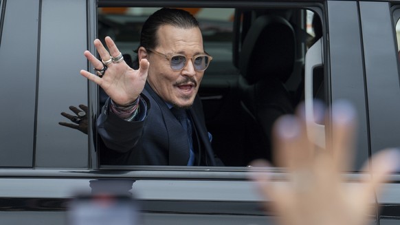 Actor Johnny Depp waves to supporters as he departs the Fairfax County Courthouse Friday, May 27, 2022 in Fairfax, Va. A jury heard closing arguments in Johnny Depp&#039;s high-profile libel lawsuit a ...