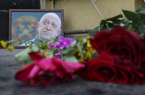 epa10817920 A picture of PMC Wagner chief Yevgeny Prigozhin is seen at an informal memorial in downtown of Rostov-on Don, Russia, 24 August 2023. An investigation was launched into the crash of an air ...