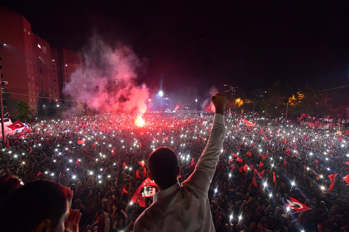 epa07669627 A handout photo made available by the CHP Press office shows newly elected Istanbul Mayor Ekrem Imamoglu of Republican People's Party (CHP) greets his supporters as they gather during ...