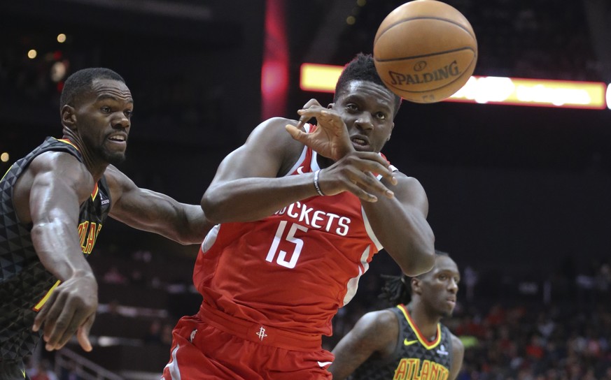 Houston Rockets center Clint Capela (15) has the ball knocked away by Atlanta Hawks center Dewayne Dedmon, left, during the second half of an NBA basketball game Friday, Nov. 3, 2017, in Atlanta. (AP  ...