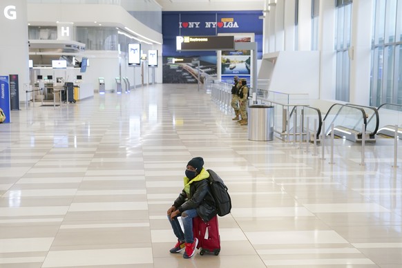 A traveler arrives at Terminal C at LaGuardia Airport, Wednesday, Nov. 25, 2020, in the Queens borough of New York. Millions of Americans are taking to the skies and hitting the road ahead of Thanksgi ...
