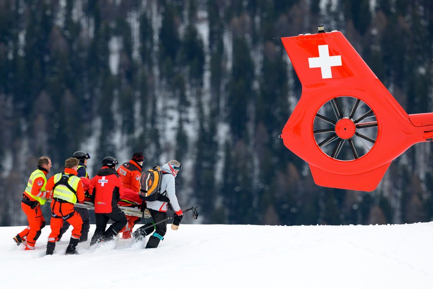 Michelle Gisin of Switzerland is being carried on a stretcher after a fall during an alpine ski, women's World Cup downhill training, in St. Moritz, Switzerland, Thursday, Dec. 11, 2025. (Keyston ...
