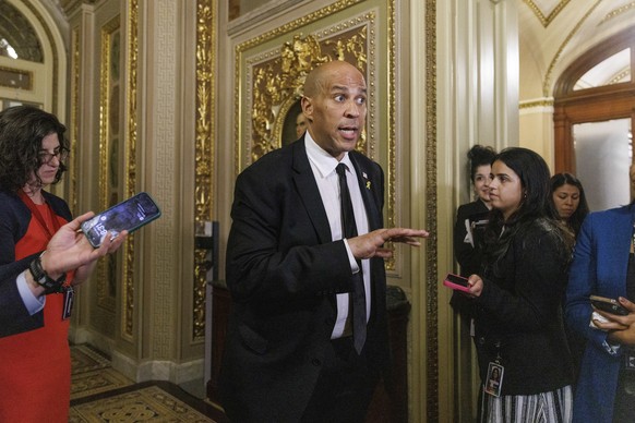 epaselect epa12004153 US Senator Cory Booker (Democrat of New Jersey) speaks to the media off the Senate floor after completing a record-breaking 25-hour, 5-minute filibuster in opposition to US Presi ...