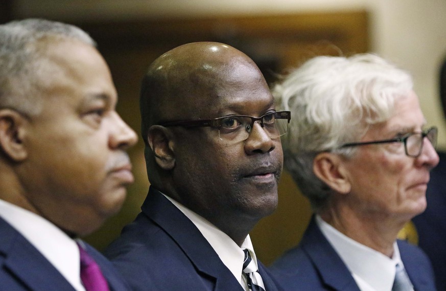 Defendant Curtis Flowers, center, stands with his attorneys, Henderson Hill, left, and Rob McDuff, at a bail hearing in Winona, Miss., Monday, Dec. 16, 2019. Flowers has been tried six times for murde ...