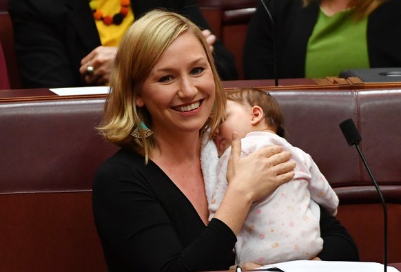 epa06093773 (FILE) - Australian Greens Senator Larissa Waters soothes baby Alia Joy after breastfeeding her during a division in the Senate Chamber at Parliament House in Canberra, Australian Capital  ...