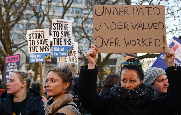 epa10367199 NHS nurses gather outside St. Thomas' Hospital in London, UK, December 15, 2022. NHS nurses in Britain have gone on strike, making it the largest strike in NHS history.  tens of thousands...