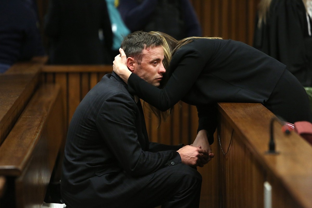 Oscar Pistorius, hugs his sister Aimee, right, in the High Court in Pretoria, South Africa, Wednesday, June 15, 2016 on the third day of the double-amputee runner's sentencing hearing for murderi ...