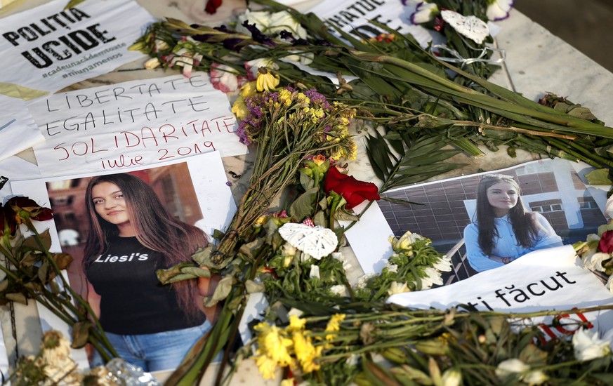 epa07748453 The portraits of kidnapped, raped and killed Romanian girl, is surrounded by wilting flowers and messages, at a makeshift memorial in front of Romanian Interior Ministry headquarters, in B ...