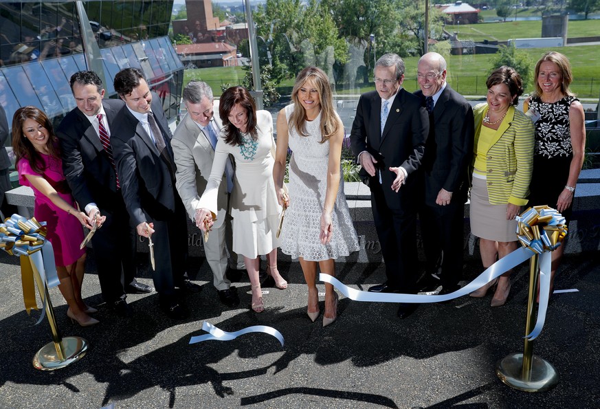First lady Melania Trump, center, participates in a ribbon cutting ceremony and grand opening of the Bunny Mellon Healing garden at Children&#039;s National Hospital in Washington, Friday, April 28, 2 ...
