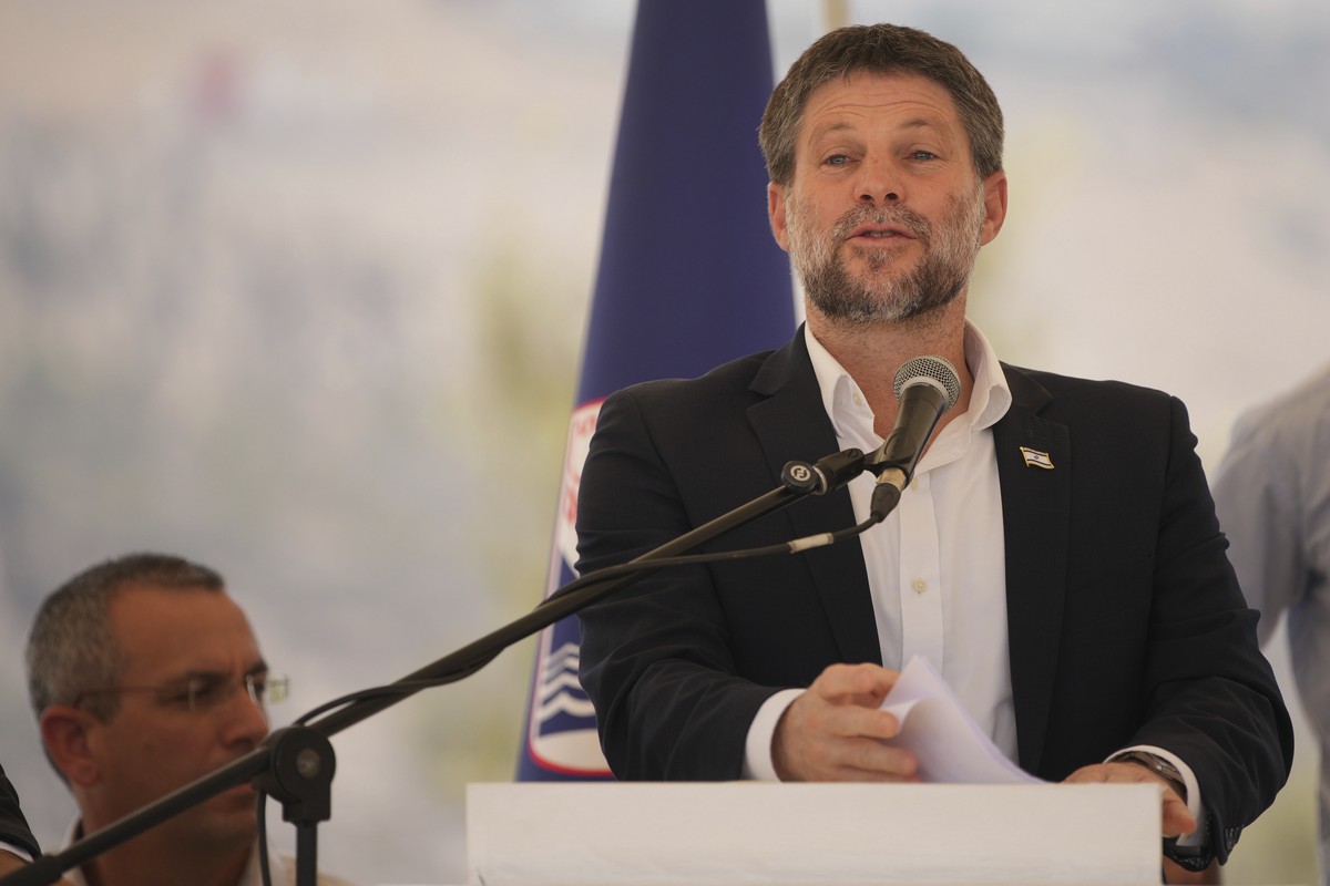 CORRECTS DAY Israeli Finance Minister Bezalel Smotrich speaks to journalists during a press conference about new settlement construction in the Israel-occupied West Bank near Maale Adumim, Thursday, A ...