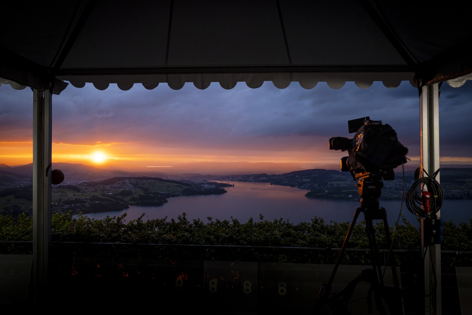 A broadcast camera is seen in front of the Lake Lucerne at sunset during the Summit on peace in Ukraine, in Stansstad near Lucerne, Switzerland, Saturday, June 15, 2024. Heads of state from around the ...