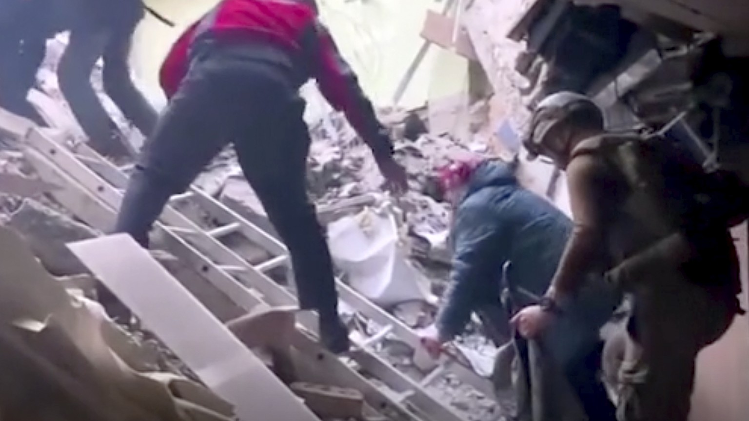 FILE - This frame taken from an undated video provided Sunday, May 1, 2022, by the Azov Special Forces Regiment of the Ukrainian National Guard shows people climbing over debris at the Azovstal steel  ...