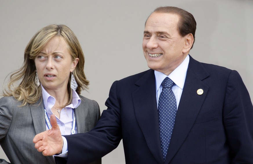 FILE �?? Italian Prime Minister Silvio Berlusconi, right, shares a word with Italian Minister for Youth Giorgia Meloni prior to a group photo of G8 and G5 leaders at the G8 summit in L&#039;Aquila, It ...