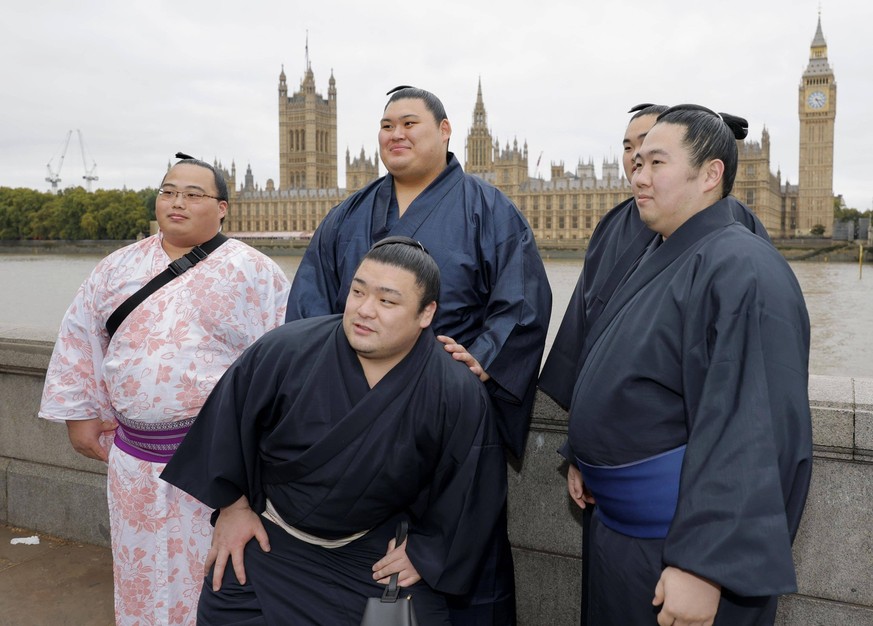 Sumo: London tournament Sumo wrestlers, including yokozuna Onosato 2nd from L, back row, pose alongside the River Thames in London, with the Houses of Parliament and Big Ben in the background, on Oct. ...