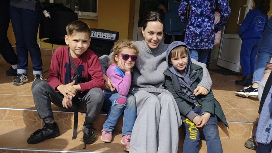 In this image provided by the Lviv city hall Angelina Jolie, Hollywood movie star and UNHCR goodwill ambassador, poses for photo with kids in Lviv, Ukraine, Saturday, Apr. 30, 2022. Ms Jolie was in Uk ...