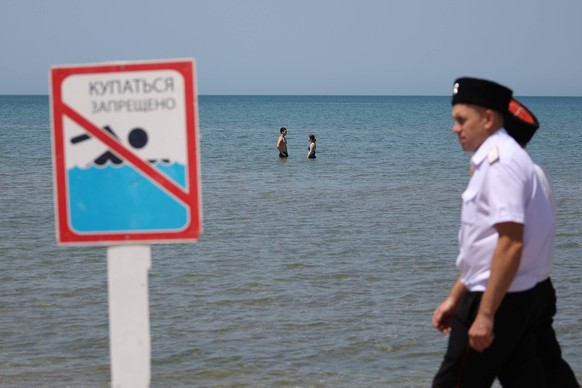 Russia Tankers Crash Aftermath 8941502 08.06.2025 Cossacks patrol banned beach areas asking trespassers to leave, in Anapa, Russia. Restrictions on beach access and warning banners have been put up al ...