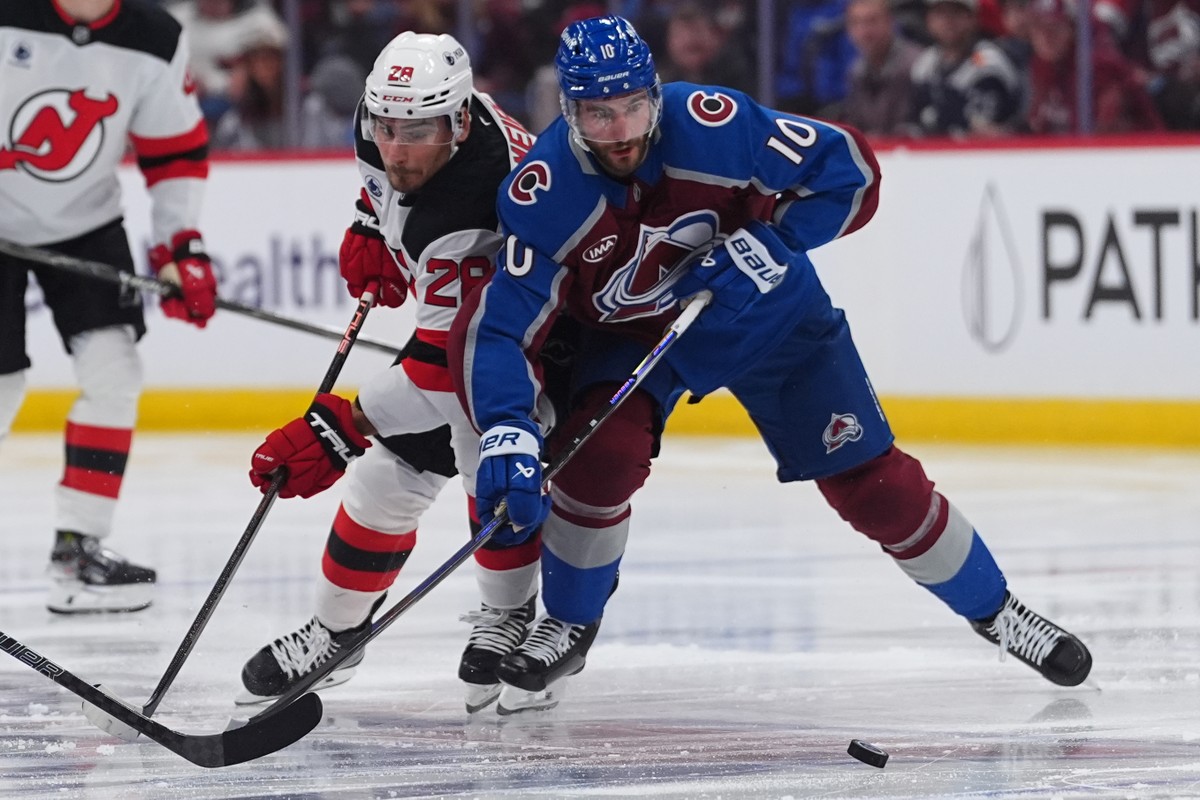 Colorado Avalanche center Nicolas Roy, right, and New Jersey Devils right wing Timo Meier pursue the puck in the second period of an NHL hockey game Wednesday, Oct. 28, 2026, in Denver. (AP Photo/Davi ...
