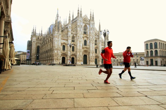 epa08821945 The Piazza del Duomo square with the cathedral in the background is almost empty in Milan, Italy, 15 November 2020, during the second wave of the Covid-19 coronavirus pandemic. Lombardy re ...