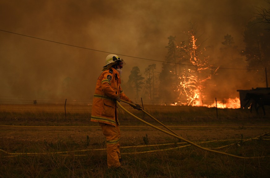 epa08084523 NSW Rural Fire Service crews fight the Gospers Mountain Fire as it impacts a property at Bilpin, in the Blue Mountains, west of Sydney, New South Wales (NSW), Australia, 21 December 2019.  ...
