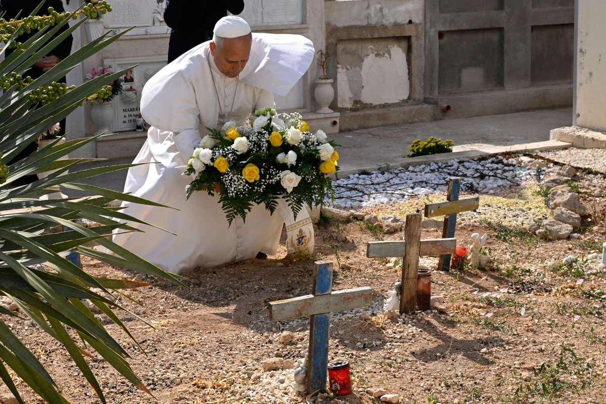 Pope Leo XIV pays tribute at the cemetery and on little Joussef's grave, in Lampedusa, Sicily, southern Italy, Saturday, July 4, 2026, during a one-day pastoral visit to an island that has become ...