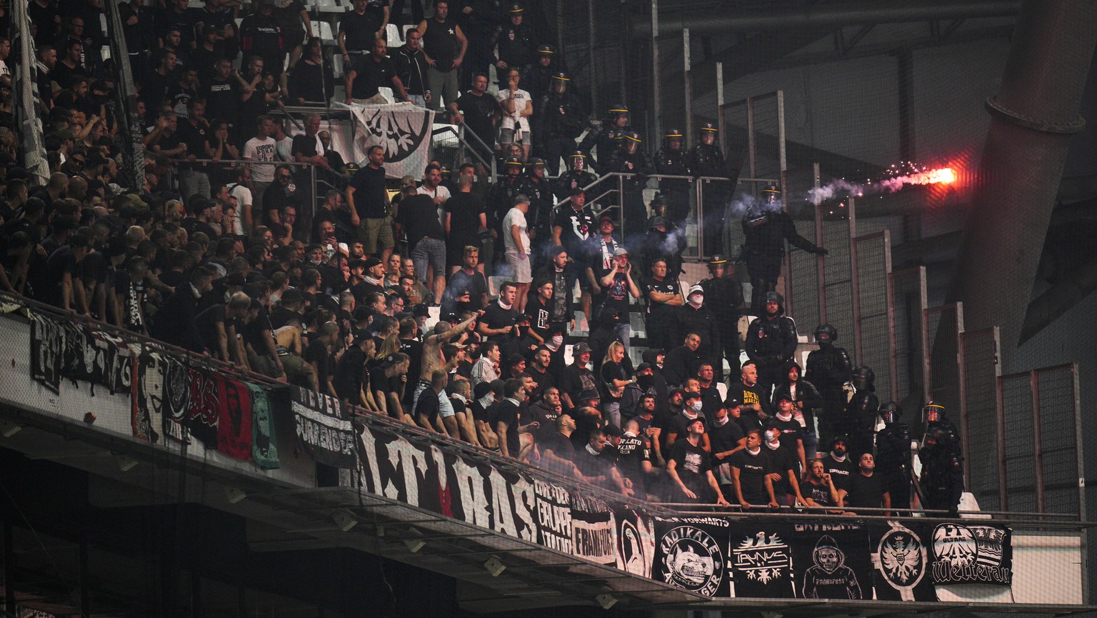 Frankfurt supporters throw a flare towards Marseille supporters prior the Champions League group D soccer match between Marseille and Frankfurt at the Velodrome stadium in Marseille, southern France,  ...