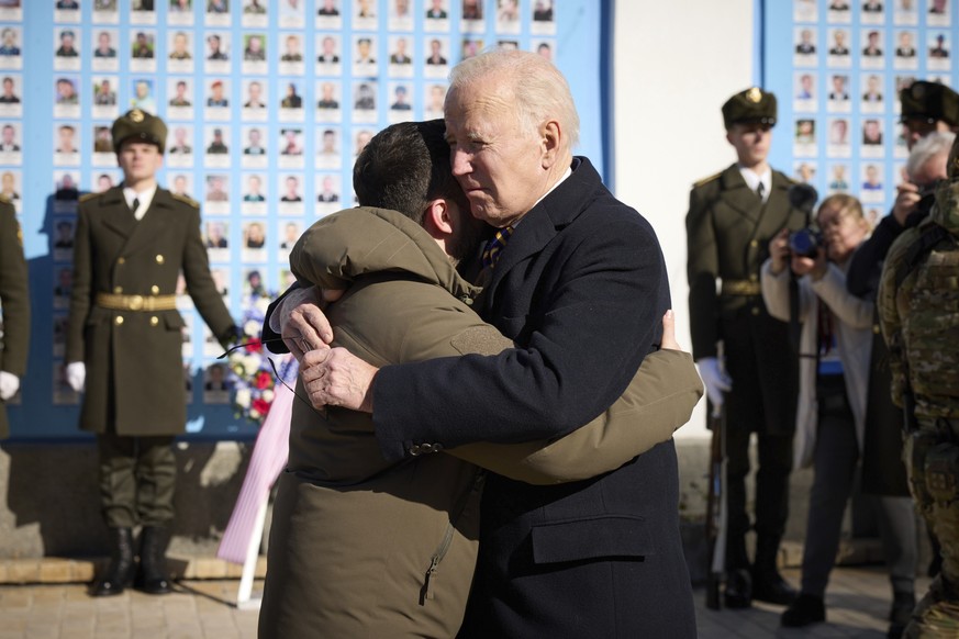 President Joe Biden, right, and Ukrainian President Volodymyr Zelenskyy hug as they say goodbye at the Memorial Wall of Fallen Defenders of Ukraine in Russian-Ukrainian War, in Kyiv, Ukraine, Monday,  ...