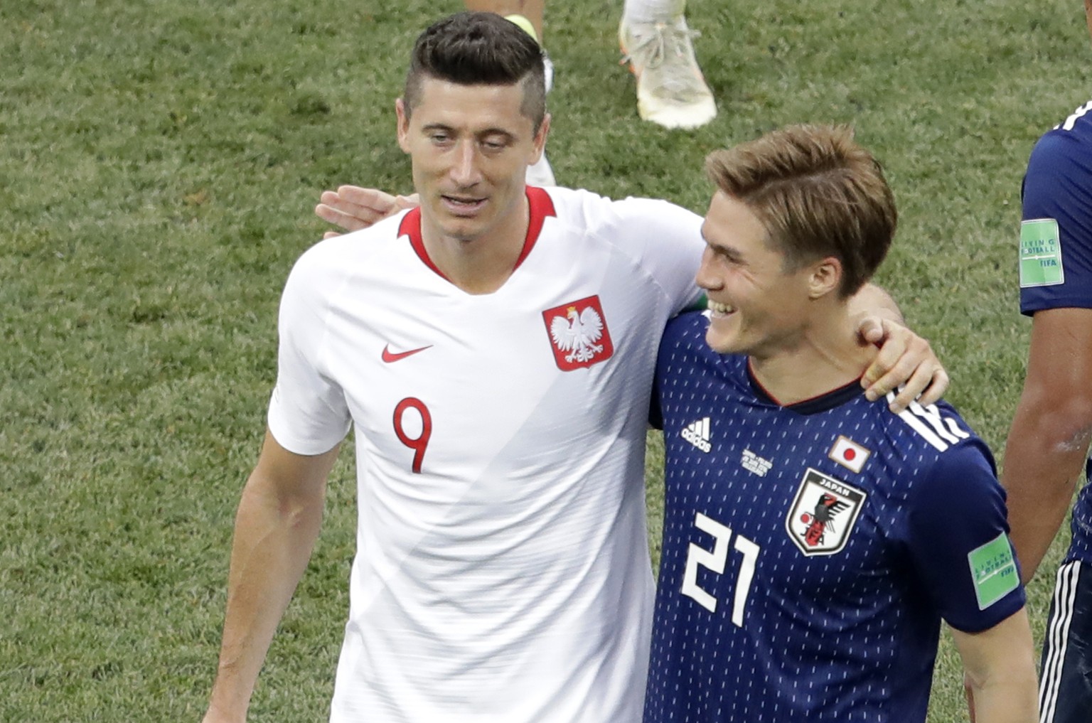 Poland&#039;s Robert Lewandowski, left, and Japan&#039;s Gotoku Sakai embrace each other at the end of the group H match between Japan and Poland at the 2018 soccer World Cup at the Volgograd Arena in ...